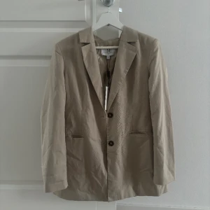 Kavaj beige  - Säljer min fina kavaj från NAKD, aldrig använd. Storlek 38