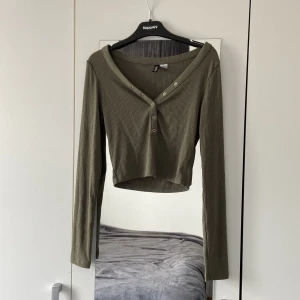 Mulvadsgrön topp  - En Topp från HM Divided som inte kom till så mycket användning den är använd ett få tal gånger, köptes 2022 men har bara hängt i garderoben, vill bara bli av med den🙃 Storleken är XS