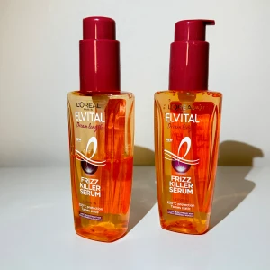 L'Oréal Paris Elvital Dream Length Frizz Killer Serum - Säljer 1 1/2 flaska av L'Oréal Paris Elvital Dream Length Frizz Killer Serum och. Detta serum är perfekt för att tämja frissigt hår och skydda det mot värme upp till 230°C. Varje flaska innehåller 100 ml av produkten och kommer i en snygg orange flaska med en röd pump. Perfekt för att få ett slätt och glansigt hår! 