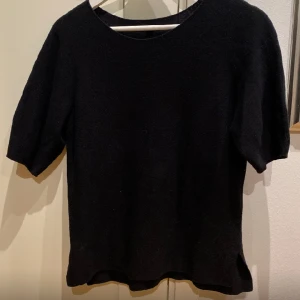 Svart stickad T-shirt  - Svart stickad T-shirt från Uniqlo. I fint skick