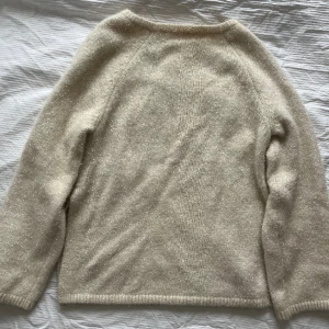 Glittrig stickad tröja - Glittrig krämvit stickad tröja från H&M. Strl XS men skulle mer säga M. Lite sminkfläckar på insidan av kragen (bild 2). Slits i sidorna. Hör av er vid frågor! 😊 Frakt inkluderad i priset. 
