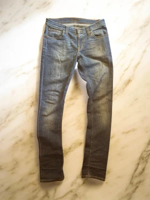 Nudie Jeans - Säljer ett par riktigt schyssta jeans från Nudie jeans med otrolig tvätt, sitter storlek 28 / 32 och är i modellen Grim Tim. Hör av dig vid minsta fundering och jag fraktar alltid inom 24 timmar. pris kan diskuteras vid snabb affär☺️