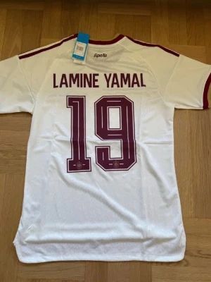 Lamine Yamal #19 – Player Edition Spanien (storlek M) - Lamine Yamal #19-tryck. Player Edition Spanien. Storlek M. Helt ny och aldrig använd. Skickas snabbt 🚚💨  Mått (M): Halvt bröstmått 51 cm • Längd 72,5 cm • Ärmbredd 22,5 cm • Axelbredd 43 cm • Ärmlängd 39 cm • Manschett 18 cm.  🔥 Player Edition – tajtare passform än vanliga supportertröjor. 🇪🇸 Spanien landslag.  📩 Skicka gärna ett meddelande vid frågor eller prisförslag! 🛍 Bundle-rabatt upp till 20%! 📦 Skickas samma eller nästa dag.