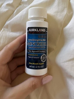 Kirkland Minoxidil 5% lösning 60 ml - Kirkland Signature Minoxidil 5% är en doftfri topisk lösning för hårtillväxt, speciellt framtagen för män och kvinnor . Flaskan innehåller 60 ml och räcker i en månad. Produkten är vit med blå etikett och skruvlock.