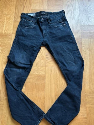 Mörkblå slim fit jeans från Replay - Snygga mörkblå jeans från Replay i slim fit-modell. Klassisk femficksdesign, låg midja och smala ben. Jeansen har subtila slitningar och är tillverkade i stretchigt denim för extra komfort.