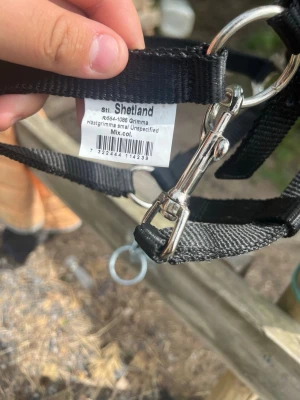 Svart hästgrimma Shetland - Säljer en svart hästgrimma i storlek small från Shetland. Grimman är tillverkad i slitstark nylon med metallspännen och ringar. Passar till mindre hästar eller ponnyer. Enkel att justera och smidig att använda i stallet.