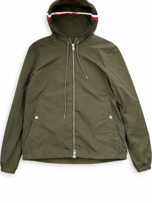 Olivgrön vindjacka från Moncler - Snygg olivgrön vindjacka från Moncler med huva och dragsko. Jackan har hel dragkedja, två fickor med tryckknappar och Moncler-logga på ärmen. Materialet är tunt och vattenavvisande, perfekt för blåsiga dagar. Röd, vit och blå detalj på huvan. Skriv till om ni har några funderingar!