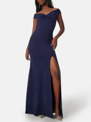 Marinblå långklänning med slits - Säljer denna klänning, använts vid ett tillfälle. Elegant marinblå långklänning med offshoulder-skärning och snygg slits på ena sidan. Perfekt för speciella tillfällen och fester.