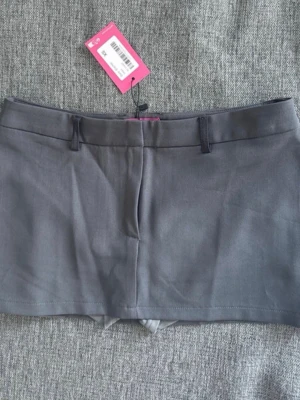 Miniskirt - Grå kostym miniskirt med shorts under. Helt ny, endast testad, XS, från edikted, midjemått 36cm. Från Edikted
