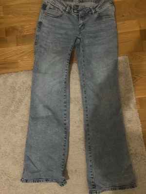 Ljusblå raka jeans - Säljer ett par ljusblå jeans med rak passform och detaljer på baksidan av jeansen, säljer för att dom är lite för stora, aldrig använda och är i superbra skick.