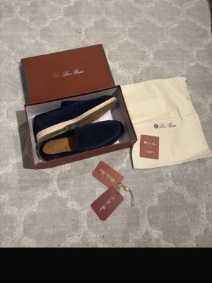 Loro Piana loafers - Snygga loafers från Loro Piana i mörkblå mocka med ljus sula. Klassisk och stilren design med diskreta sömmar och bekväm innersula. Perfekta för en avslappnad men ändå uppklädd look.