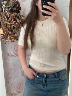 Ribbad beige t-shirt med trekvartsärm - Snygg ribbad t-shirt i beige med trekvartsärm och rund hals. Storlek S men funkar definitivt som M,inte så figurnära och ganska lös❣️