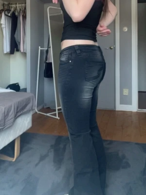 Svarta utsvängda low waist jeans - Snygga svarta jeans med ultra låg midja och utsvängda ben från Gina tricot 14+ teen. Jeansen har klassisk femficksdesign och en tight passform upptill som blir vidare nedtill. Inte använda då dem inte passar