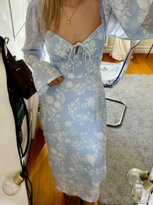 Ljusblå klänning - Ljusblå klänning med knyte framtill och dragkedja där bak. Endast använd två gånger så i väldigt bra skick!