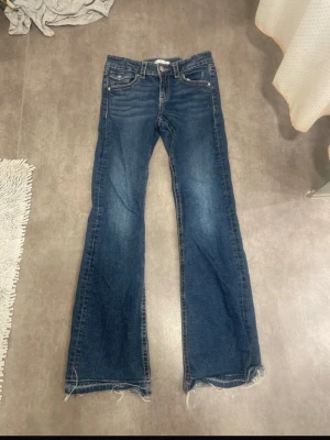 mörkblåa gina jeans  - Säljer ett par perfekta flare jeans i storlek 164. Har sprättat upp fållen på jeansen alltså har jag förlängt dem. Man kan justera midjan efter sin storlek. Jeansen ser bra ut och är i mycket bra skick då jag inte använt dem så mycket.