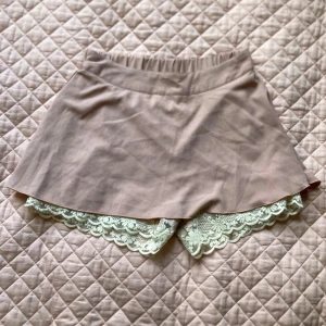 Rosa bloomer shorts - Rosa bloomer shorts. Det är alltså bloomers med en rosa ( dammrosa) kjol över. Köpte i Japan för flera år sedan så har ingen information kring märke eller storlek. Skulle uppskatta att de är storlek S/XS. Några små defekter (se bilder)