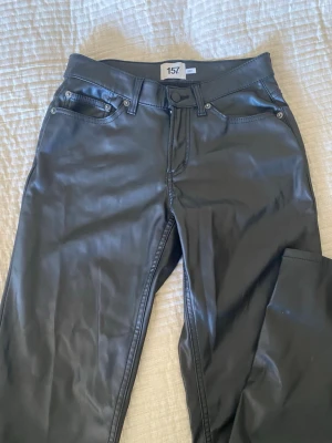 Svarta coated jeans från 157 - Snygga svarta coated jeans från 157