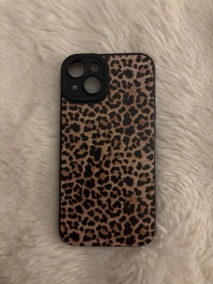 Iphonecase 14 - Ett leopard mönstrat telefonskal med svarta detaljer för iPhone 14. Mobilskalet är använt 3 ggr men är fortfarande i nytt skick❣️❣️