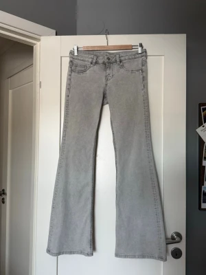 Gråa bootcut jeans med lågmidja  - Säljer ett par ljusgrå bootcut jeans med lågmidja, den passar perfekt till våren! 