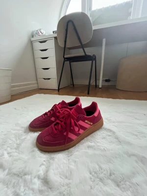 Ett par snygga sommar adidas’s spezial skor  - Här är ett par snygga rosa och somriga skor med en ljus rosa och en mörk rosa färg.