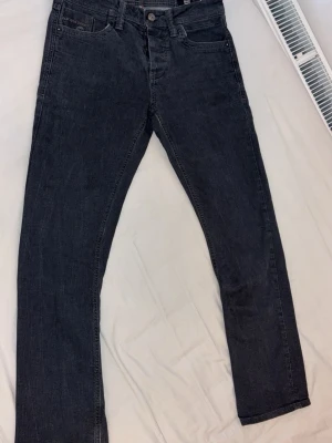 Svarta  jeans Jack & Jones - Snygga svarta jeans med rak passform och klassisk femficksdesign. Jeansen har normal midja och är tillverkade i denim med en lätt stretch för extra komfort. Perfekta för dig som gillar en stilren look. Storlek 31-32