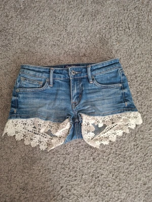Crocker jeans shorts med spets dam - Jeans shorts med vit spets i strl xxs med låg midja. Använd men är i mycket fint skick. Märket är Crocker Authentic Jeans som är ett välkänt märke som gick i konkurs 2019. Populära då de är svåra att få tag på, så jag rekomenderar att köpa snabbt!🤍