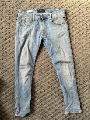 Ljusblå skinny jeans från Replay - Snygga ljusblå skinny jeans från Replay med klassisk femficksdesign och dragkedjegylf. Jeansen har en tvättad look och smal passform som sitter tajt längs benen. Perfekta för en avslappnad och trendig stil.