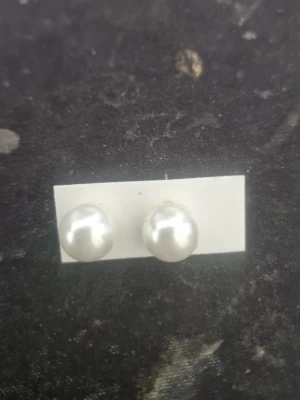 Klassiska pärlörhängen i silverfärg - Snygga örhängen med vita, runda pärlor och stift i silverfärg. Perfekta för dig som gillar en stilren och tidlös look. Passar till många olika outfits och är lätta att bära hela dagen.