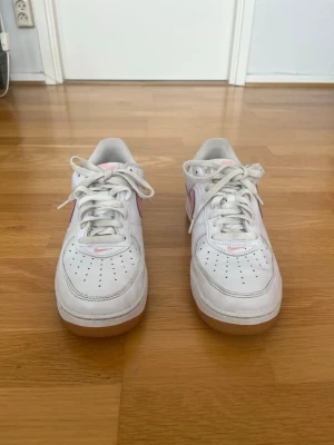 Nike Air Force 1 Low Retro White Pink – Storlek 44 - Säljer ett par Nike Air Force 1 Low Retro Color of the Month 'White Pink' i storlek 44. En snygg och populär colorway från “Color of the Month”-serien med vit läderovandel, rosa swoosh och klassisk gum-sula. Skorna är använda men i bra skick med normalt slitage. Fortfarande fräscha och väldigt bekväma för vardagsbruk. Perfekta för dig som vill ha ett par stilrena retro Air Force 1 med lite färgdetaljer