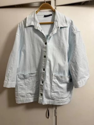 Ljusblå oversized jeansjacka - Säljer en ljusblå oversized jeansjacka från MASAI med stora framfickor och knappar framtill. Jackan har avslappnad passform, klassisk krage och raka ärmar. Perfekt för dig som gillar en chill och trendig stil.