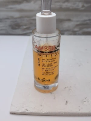 Farmona Amberray Bright Shock Toner serum 50ml 80% kvar - Amberray Bright Shock toner från Farmona är ett multifunktionellt, lystergivande ansiktsserum i en genomskinlig glasflaska med pipett. Perfekt för dig som vill ha glow och fräsch känsla. Innehåller micro collagen för snabb effekt som verkar på djupet.