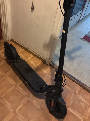 Svart elscooter från ninebot - Elektrisk scooter i svart från Ninebot med digital display på styret som visar hastighet och batterinivå. Scootern har robust ram, stora hjul och reflexer fram. Perfekt för smidig transport i stan och enkel att använda. (Pris kan diskuteras)