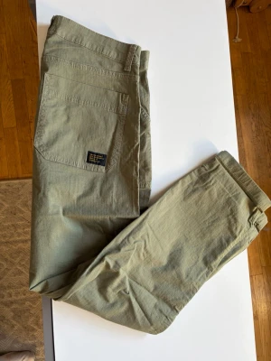Olivgröna cargobyxor från Vailent - Säljer ett par olivgröna cargobyxor från Vailent. Byxorna har stora fickor på sidorna och en svart. Tillverkade i slitstarkt bomullstyg.