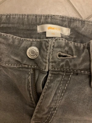 Grå jeans från Gina Tricot - Säljer ett par grå jeans från Gina Tricot i storlek 158. Jeansen har klassisk femficksmodell med knapp och dragkedja framtill samt en ficka med lock bak. Snygga kontrastsömmar och bälteshällor. Perfekta till en avslappnad look.ASSNYGGA SE MIN ANDRA ANNONS❤️❤️❤️har prissänkt med 50%btw