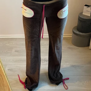 Bruna mjukisbyxor från MISS SIXTY  - Bruna vintage mjukisbyxor i velour med vita kontrastfickor och rosa detaljer, storlek XS men passar även S. Byxorna har dragsko i midjan och vid bensluten för justerbar passform. Lite fläckar på fickan. 