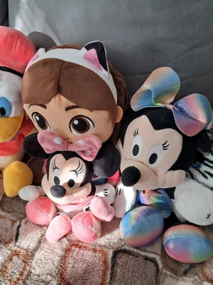 Gosedjursgänget söker nytt hem! - Gosedjursgänget söker nytt hem!  Mimmi Pigg i regnbågsklänning älskar selfies och att sprida glädje. Kalle Anka i röd tröja och blå byxor kan vara lite småsur men väldigt charmig. Flicka är mjuk och kramgo – perfekt filmkompis. Mimmi-bebis är liten, söt och redo för massor av kramar. Zebran är svartvit, unik och får alla att le.  De stora är ca 50 cm, färgglada, mjuka och nytvättade! Perfekta i barnrum eller soffan. Paketpris för hela gänget – kan även säljas separat. Föreslå gärna ditt pris!