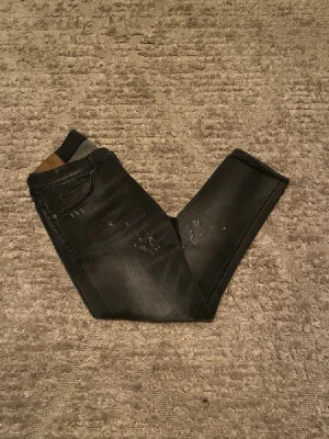 Dondup George jeans - Hej jag säljer ett par otroligt unika Dondup George jeans med sällsynt slitning i riktigt snygg grå färg perfekt för dig som vill ha ett par kvalitetsjeans med grym passform. Nypris ≈ 4000kr, mitt pris 799kr.  Skick: 9/10 Storlek: W35 Midja: 40cm Lår: 25cm Ytterlängd: 90cm Innerlängd: 66cm  Skriv gärna om du vill ha fler bilder eller har frågor!