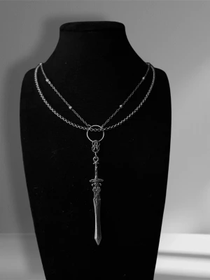 Handmade sword necklace in stainless steel  - 🕷️Handmade necklace by me ⛓️Material: Stainless Steel 🖤Adjustable length 35cm+5cm  🖤Jewerly care:  – Avoid longer contact with water – Avoid excessive perfume, lotions, and chemicals – Do not sleep or exercise while wearing  Proper care helps maintain appearance and longevity ✨  Feel free to check out my other pieces- bundle discounts available💸  The price list is set based on material costs, my working hours and based on unique designs and other costs.  #gothjewelry #handmadejewelry #altjewelry #