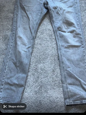 Grå Tapered jeans från Jack & Jones - Säljer ett par gråa tapered jeans från Jack & Jones, modell Tapered Mike. Jeansen har en snygg tvättad look och klassisk femficksdesign. Tillverkade i slitstarkt denimtyg och passar perfekt för en avslappnad stil.