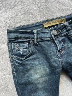 Lowwaist bootcut vintage jeans - Vintage lowwaist bootcut jeans från Acce star. Snygga silversömmar och detaljer. Storlek 28/36 och passar mig som brukar ha S/xs. Utsydda proffsigt gjort. Hör av er för fler bilder eller mer info🩷