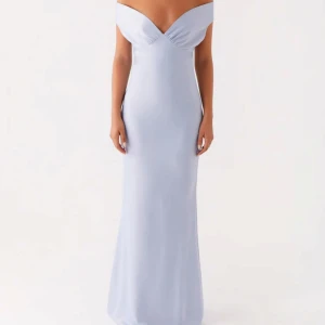 Peppermayo balklänning ljusblå axelbandslös  - Säljer en elegant ljusblå långklänning med offshoulder och v-ringad urringning. Säljer då jag bara behövde den en gång på en bal, så den är endast använd en gång och i väldigt bra skick. Skriv om du vill ha fler bilder och jag kan posta den så snart som möjligt! Klänningen har en figurnära passform och är tillverkad i ett slätt, mjukt material som ger en lyxig känsla. Perfekt för bal eller festliga tillfällen. Den är ner till fötterna på mig som är 176cm. 