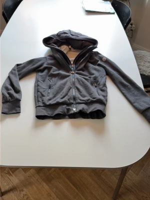 Moncler kofta - Säljer den här supersnygga moncler koffta då den har blivit förliten. Skulle passa perfekt för någon som är 165-172. Den har blivit lite missfärgad som ni ser på bild 2, men det är inget som någon märker till! Priset är ej hugget i sten!!