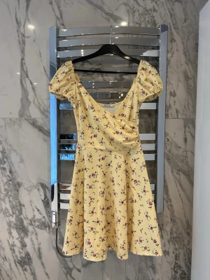 Gul blommig klänning  - Super fin gul blommig klänning från Nelly.com säljer pga att den blivit för liten. Storlek XS. 200kr köparen står för frakten!💛 Den har en liten ”reva” (syns på en av bilderna), inget som man lägger märke till. 