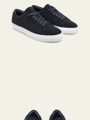 Marinblå sneakers från led deux - Stilrena marinblå sneakers från les deux med ovandel i mocka och klassisk vit platt sula. Skorna har snörning och diskret led deux detalj  bak i rött, vitt och blått. Perfekta för en clean och modern look.