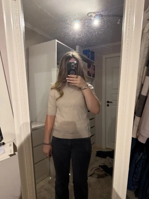 Beige stickad tröja med kort ärm från Stockholm LM - Säljer en enkel och stilren beige stickad tröja med korta ärmar och ribbade muddar. Perfekt till jeans eller kjol och funkar året runt. Tröjan har en mjuk känsla och en klassisk passform. Tröjan är bara använd 1 gång och nypriset är 700 men priset går att diskutera💕
