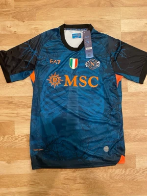 Napoli Halloween 25-26  - Napolis halloweentröja 25-26 i storlek M. Tröjan är helt ny med EA7 och Napoli loggan på bröstet. De Bruyne på ryggen med nr 11