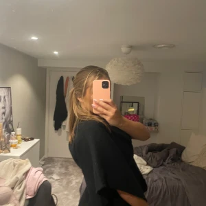 Svart  missäylikannde jacka - jackan har en omlott-look och är ärmlös med en loose passform. Perfekt att slänga över en t-shirt eller långärmad för en chill och snygg vibe. jättefin och mysig till hösten, poncho stil på den🩷🩷🩷🩷🩷