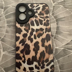 Leopardmönstrat iPhone 16 skal - Snyggt skal med leopardmönster för iPhone 16. Skalet har ett robust kameraskydd och mjuk insida för extra skydd mot repor. Perfekt för dig som vill kombinera stil med funktion. Oanvänd 
