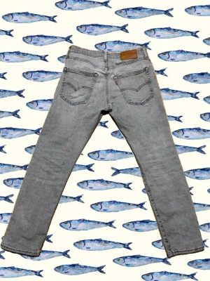 Grå Levi's 501 jeans straight fit - Snygga grå Levi's 501 jeans i klassisk straight fit. Jeansen har fem fickor, Levi's ikoniska bakfickor med söm och läderpatch i midjan. Tillverkade i mjukt jeanstyg som är skönt att bära hela dagen.