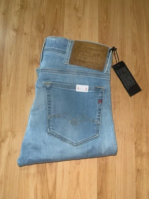 Repaly jondrill jeans  - Helt nya! Säljer dessa snygga Repaly Jondrill Jeans i fin blå färg. Midja 35cm, längd 103cm. JAG SKICKAR EJ FLER BILDER NÄR JAG BÄR JEANSEN! för bättre inblick i passformen rekommenderar jag att googla på modellnamnet. För storleksguide kolla måtten noggrant då jeansen alltid kan vara uppsydda heller krympta och jag ej tar emot returer :) 1,35